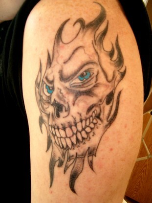 Skull tattoos and creepy tattoos, jester tattoos, gargoyle tattoos,