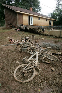 Mud encased bicycles lay strewn in front of a house in Lilburn after flood waters from the Yellow River receded from it, Wednesday, Sept. 23, 2009, in Austell, Ga. A newly built deck on the back of the house was nowhere to be found. (AP Photo/John Amis)