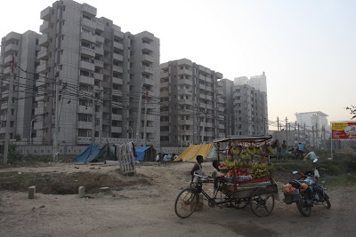 The main road in Gurgaon. Huge developments going in there with massive luxury apartments and still the roadside vendors. The main road in Gurgaon. Huge developments going in there with massive luxury apartments and still the roadside vendors.