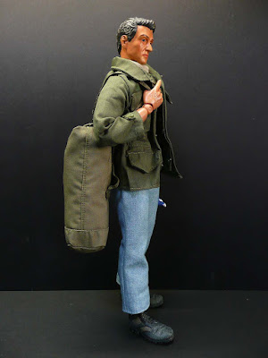 John Rambo with his M65 jacket and duffel bag plus folded flag
