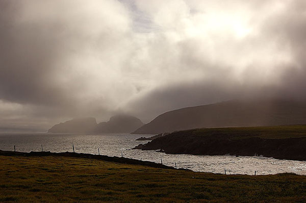 Vun St. Finian's Bay aus, d'Puffin Island am Hannergrond