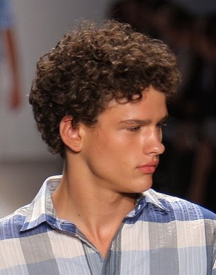 2006 men quiff hairstyle. Short curly hair was brushed away from the face