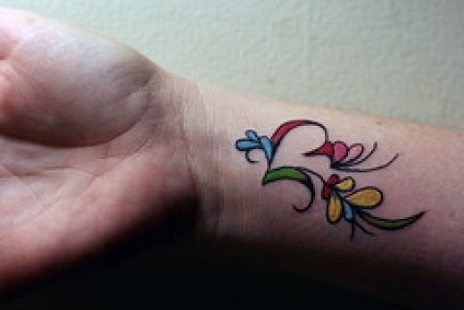 love tattoos on wrist for girls. I just love the colours in this wrist tattoo and tis a perfect tattoo for 