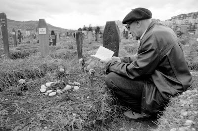 Bosnia,+Sarajevo,+Senior+man+reading+Koran+by+grave+in+cemetery.jpg