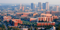 Foggy aerial view of the predominately red brick buildings of varying heights that make up the University of Alabama at Birmingham campus.