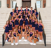 SMU cheerleading team in blue uniforms on steps.