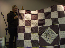 Trapunto embroidered quilt