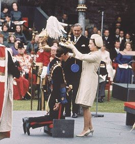 Queen Elizabeth II places a crown on her son's head as Prince Charles, 20, is invested as Prince of Wales on July 1, 1969, at Caernarfon Castle in Wales. (AP Photo)