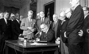President Lyndon B. Johnson signs the civil rights bill July 2, 1964, in the East Room of the White House. Standing behind Johnson, center, is Sen. Hubert Humphrey, D-Minn. (AP Photo) 'Happy Warrior' nothing, we're wondering about that hand on the right.