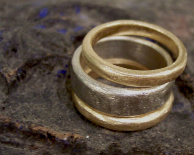 Bands of recycled white and yellow gold with an organic filed shape and