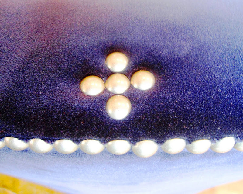 Close up of pewter nail head trim design detail on blue velvet upholstery