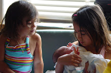 Alyssa and Emma in awe of newborn baby Rebekah
