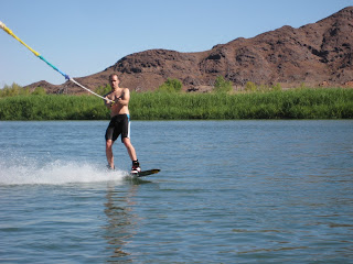 Noah wakeboarding while the water is still flat in the morning.
