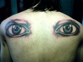 Real eye tattoo art in back