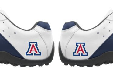 AZ Wildcats golf shoes that are white with blue trim and some red in the Arizona Wildcats logo near the sole and grip on the bottom of the athletic footwear.