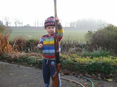 hillside in dorset and child in stripey coat licensed shotgun
