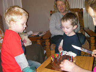 cutting the birthday cake in the lounge, willing participants