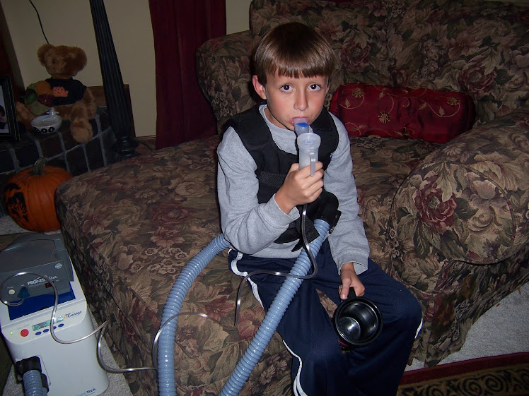 Trevor doing his vest and nebulizer treatment