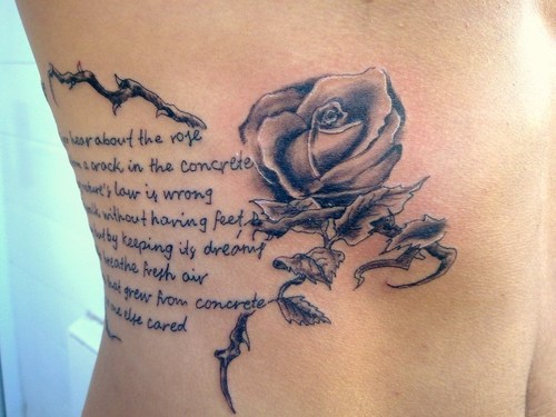 Rose tattoo and writing tattoo on side body