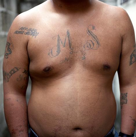 MS-13 gang members mark their upper body in Gothic.