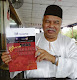 Soekarno Talib showing the cover of the book Yang Buas, Terbuang, Terbiar at a press conference