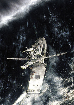 Image of a boat facing an insurmountable wave in a terrible storm.