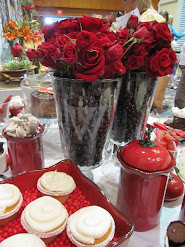 Fill a vase with red roses, tuck inside a large hurricane and surround with coffee beans-BEAUTIFUL!
