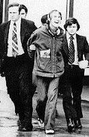 I believe McLuhan told him the smile would most annoy 'Them', especially when getting arrested