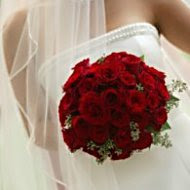 Classic red roses make this traditional bride very happy!
