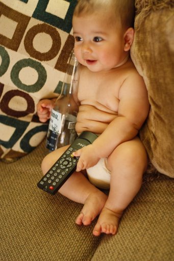 Cute baby boy drinking and watching tv model photo