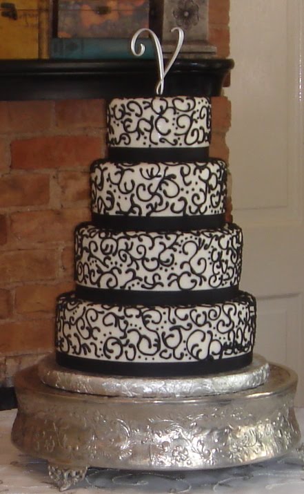 Four tier white round fondant custom wedding cake with lace like elegant 