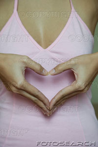 [woman-making-heart-shape-by-hands-close-up-mid-section-~-200550923-001.jpg]