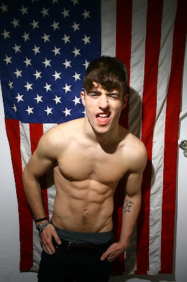 beautiful gay soldier showing off in front of flag