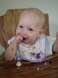 baby eating blueberries