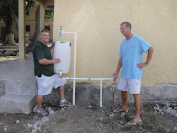 Paul and I demonstrate the newly-constructed clean water drinking station
