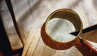 magnify glass on newspaper