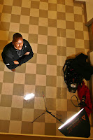 a man sitting on a checkered floor looking up
