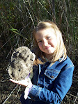 Laughing Water holding a mold of a bear print we cast