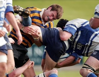 Sydney University forward Ben McCalman finishing a tackle