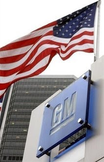 Flags fly outside the General Motors world headquarters building Detroit, Michigan. GM is widely expected … 