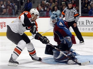 Simon Gagne puts a penalty shot past Andrew Raycroft of the Colorado Avalanche