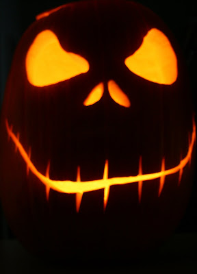 Carved Halloween pumpkin face in the dark