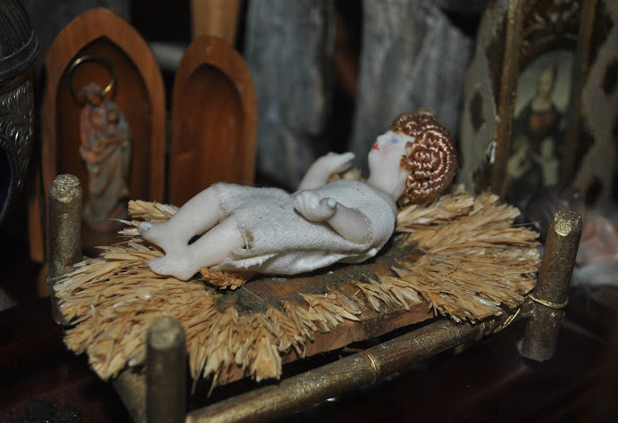 A German wax baby Jesus on a bed of straw