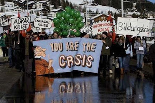 you're the crisis!: protesters rally against world economic forum