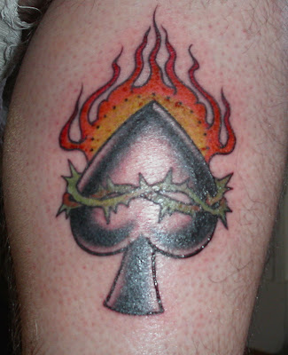A flaming spade tattoo with crown of thorns. Another nicely done tattoo with 