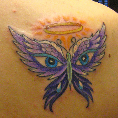 A colorful butterfly tattoo with halo. Looks like eagle eyes to me. [Source]