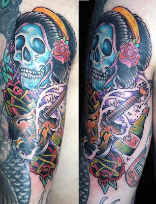extreme musical tattoo, this designs part of skull tattoo and guitar tattoo