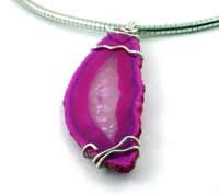 hot pink geode slice that has been wire wrapped with sterling silver