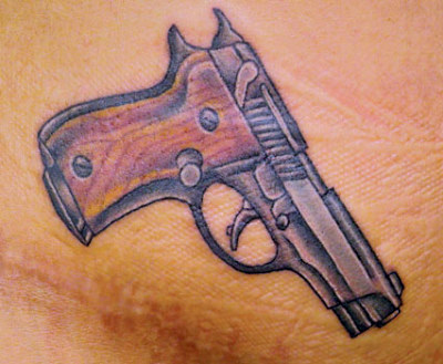 Secret weapon: Rihanna unveils controversial new gun tattoo
