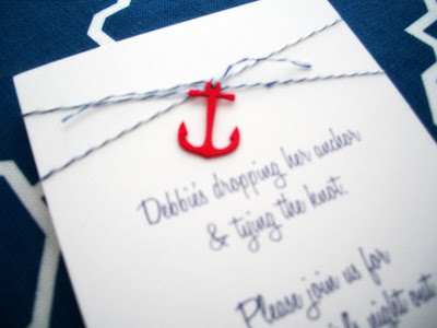 Above A red laser cut anchor was affixed to the invitation with blue and 